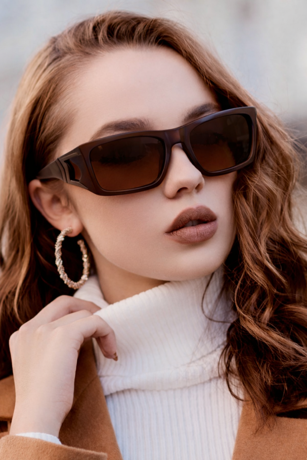 unidentified woman wearing a stylish pair of brown overset glasses and white turtleneck, ideal for wearing over regular glasses.